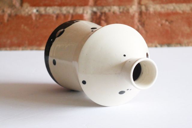 At the line where the clays meet, the dots also invert – so the top has black dots floating on a white background. The neck is slightly tapered to hold a cork.
