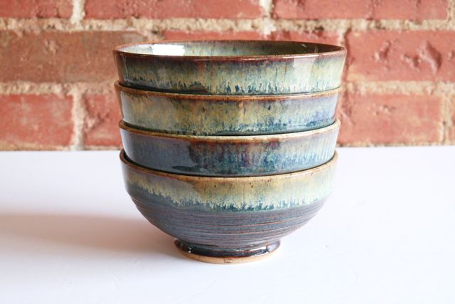 The four bowls stacked neatly fit so the inch-ribbon rim of each stacks against the previous -- each with a slight outward angle that catches the base of the next rim.
