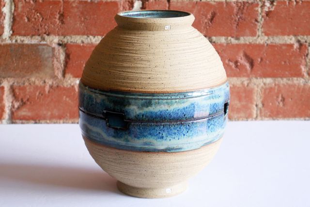 One bowl inverted on top of the other, rim to rim, a near-perfect match with chopstick notches at the same place on both.
