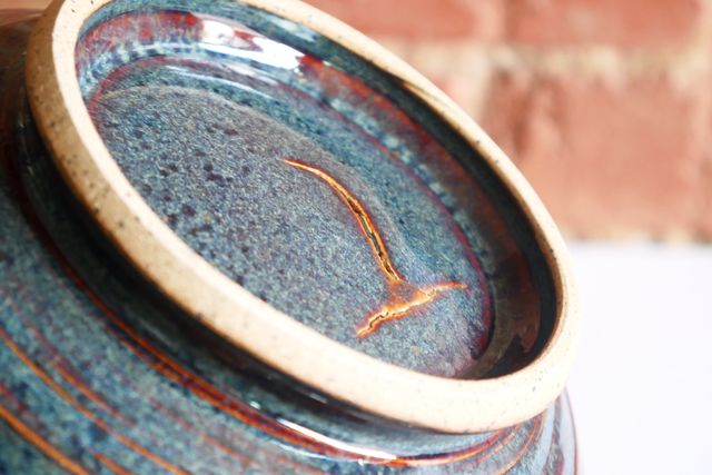 Underneath the other bowl is a similar crack filled in with glaze.
