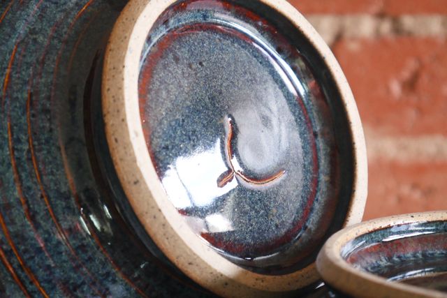 Inside the foot ring is also glazed. The bowl shown has a subtle glazed-over crack underneath the center of the bowl, only visible from below.
