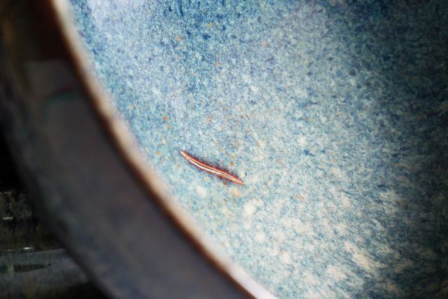 One of the two also has a small glazed-over crack showing on the inside of the bowl. The glaze breaks red-brown at the edges, highlighting the crack like a scar - but it is fully filled in, so the bowl remains perfectly functional.
