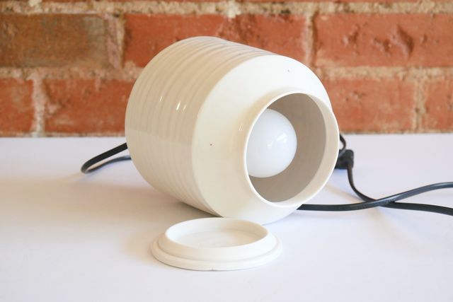 When open and viewed from above, a standard light bulb is visible inside.
