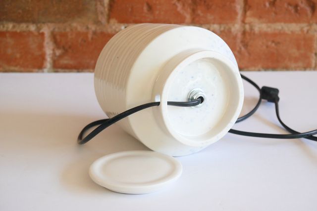 The bottom inch is a hollow foot ring with a hole cut in the back, so that the cable can get in to the socket mount in the center.
