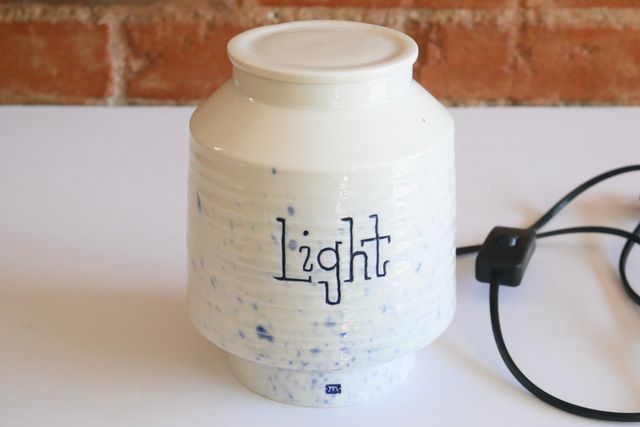 With the light off, it's a white jar with a splash of light blues, and a darker blue in the lettering and inside my small m stamp at the base.
