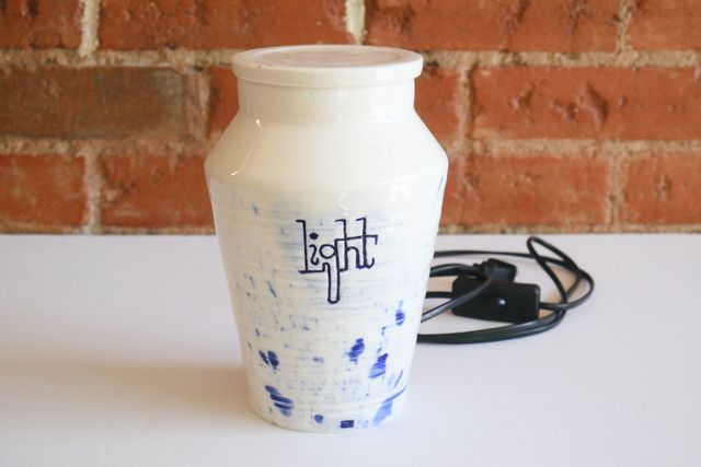 With the light off, the jar is opaque white with splashes of blue.
