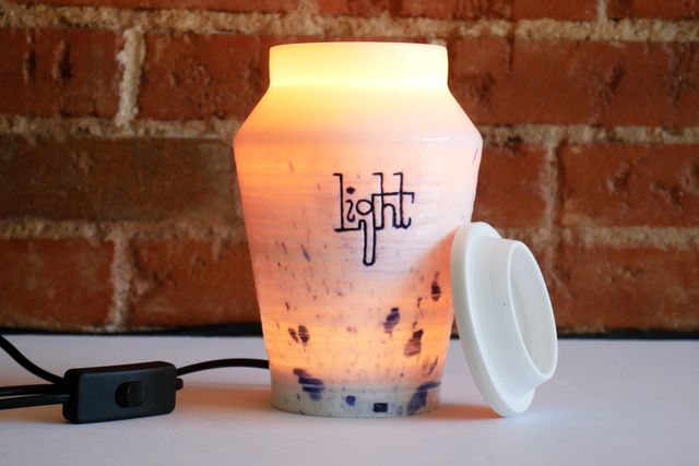 With the light on and the lid off, more light pours out the top of the jar. Only the base seems opaque.
