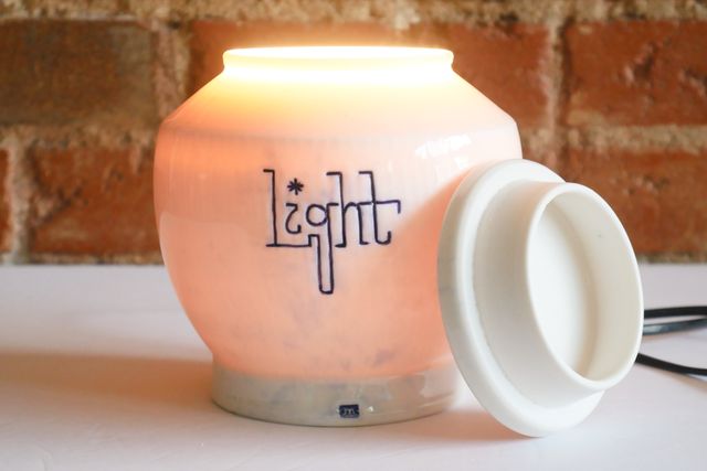Turning on the lamp with the lid off, more light pours from the top of the jar.
