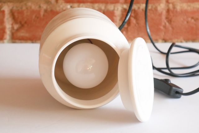 From above, with the lid off, a standard bulb is visible inside.
