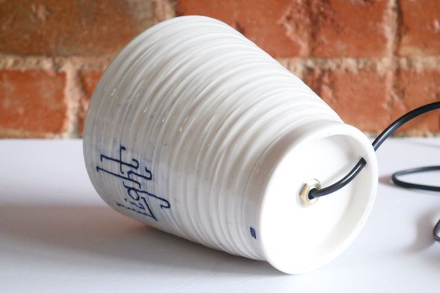 A black lamp cord with a rocker switch enters the base from the back, and continues up into the jar where the light socket is mounted.