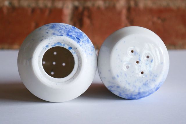 Both have five holes in the top, and a larger hole with a rubber plug hidden underneath - inside the foot ring.