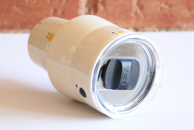 The lid is a large replacement lid for Yeti tumblers, with a clear base and black magnetic closing mechanism.