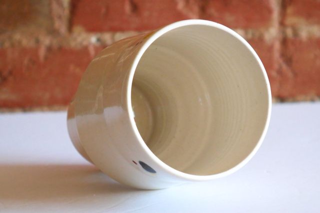 The inside is also white, and the entire piece has a glossy finish, with some subtle drips adding texture.