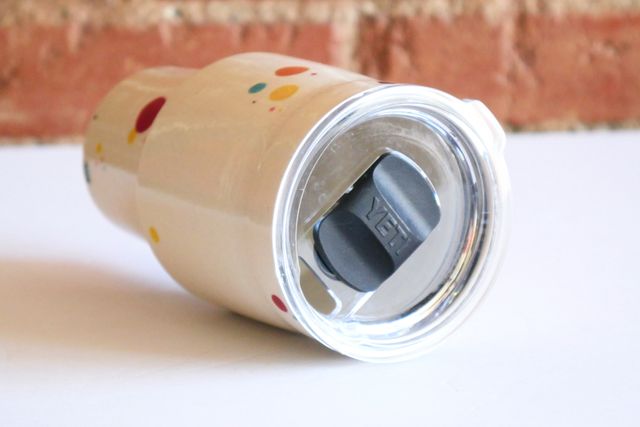 The lid is a large replacement lid for Yeti tumblers, with a clear base and black magnetic closing mechanism.